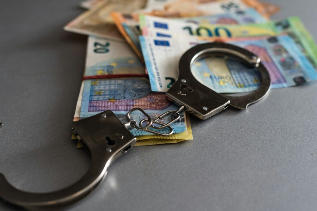 Handcuffs and euro money. Euro banknotes